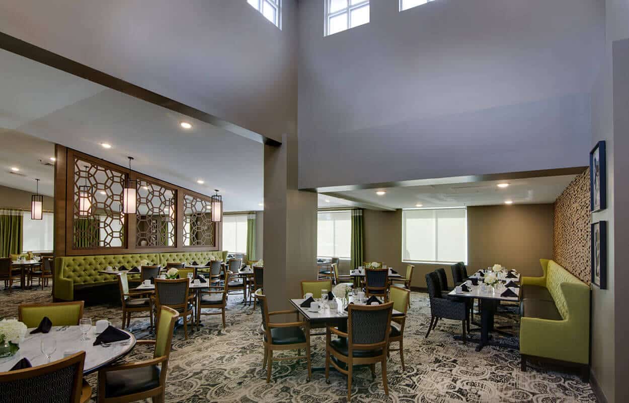 Wide angle view of dining room with tables and chairs