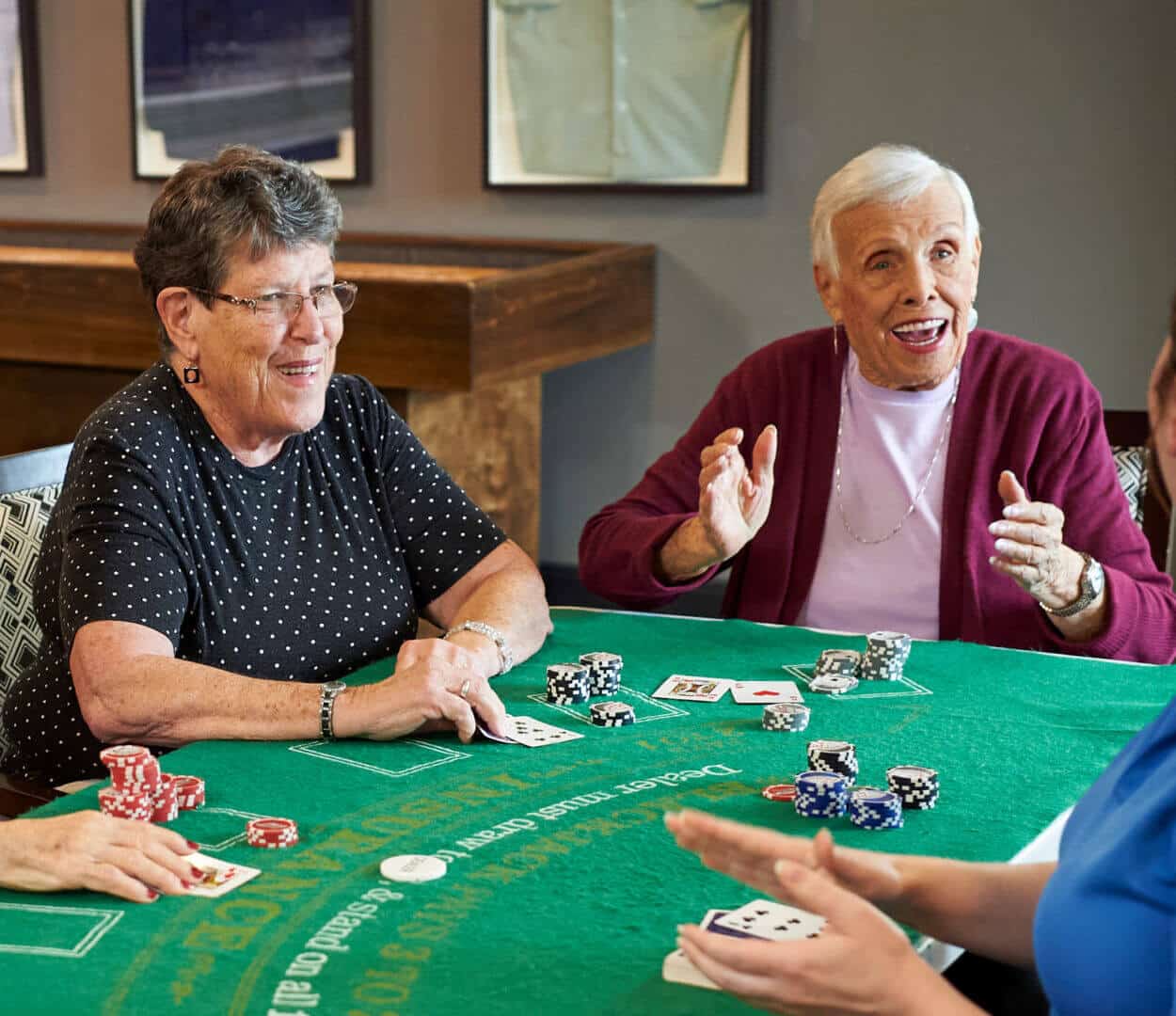 senior women seated at a blackjack table playing a game