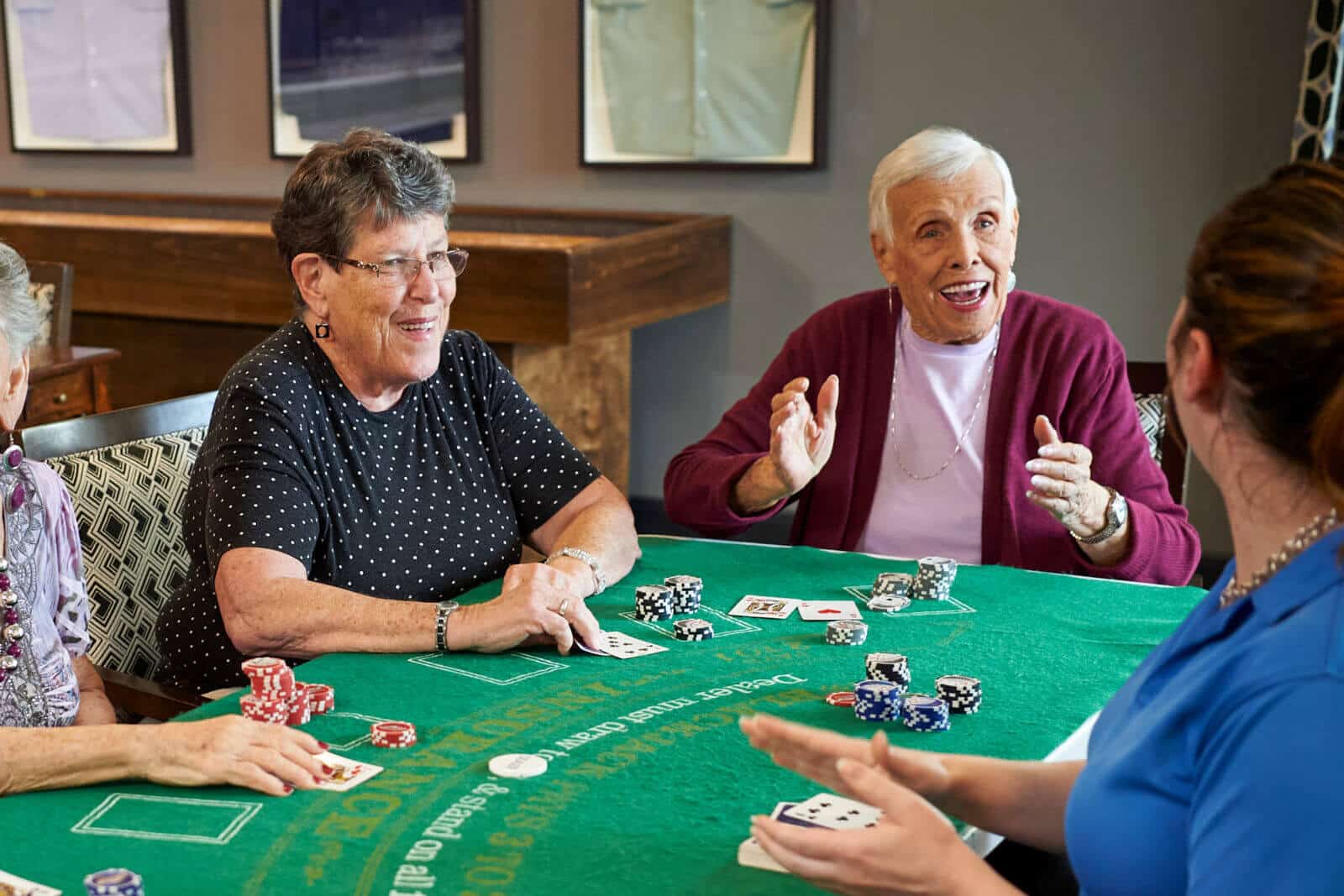 senior women seated at a blackjack table playing a game