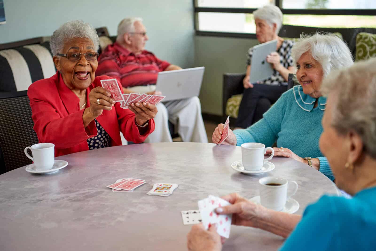 two senior residents playing a game of cards
