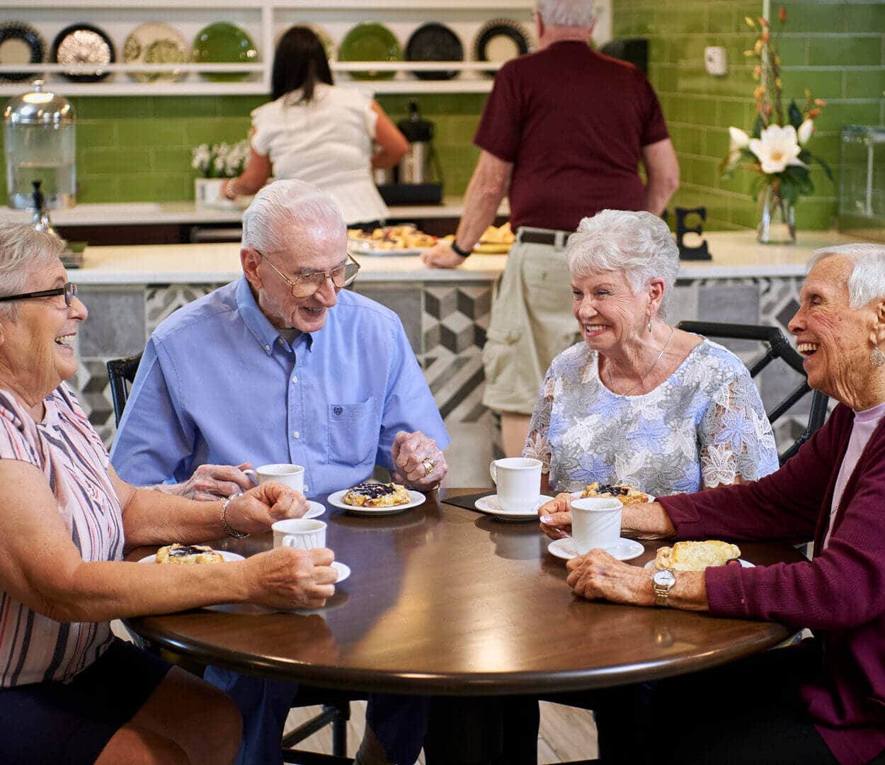 senior residents sitting in bistro drinking coffee